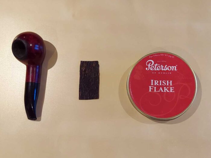 Stevens Method of Packing Flake Pipe Tobacco: we start with a pipe, flake, and battered tin of the working smoker.